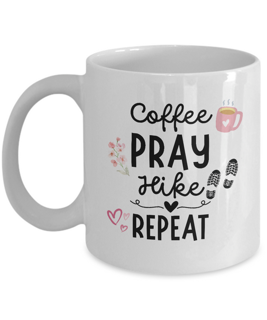 Introducing the Coffee Pray Hike Repeat Coffee Mug—an ideal gift for hikers! This white mug features charming text reading "Coffee Pray Hike Repeat" alongside delightful graphics of a coffee cup, flowers, hearts, and hiking boot prints. Order now for a limited time only and enjoy secure checkout.