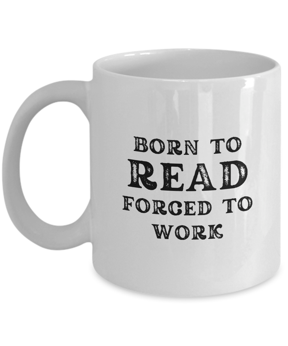 A white coffee mug called "Born to Read Forced to Work Coffee Mug" features the phrase "BORN TO READ FORGED TO WORK" printed in bold black letters. Printed and shipped from the USA, this unique mug is available for a limited time only and makes a perfect gift for readers.