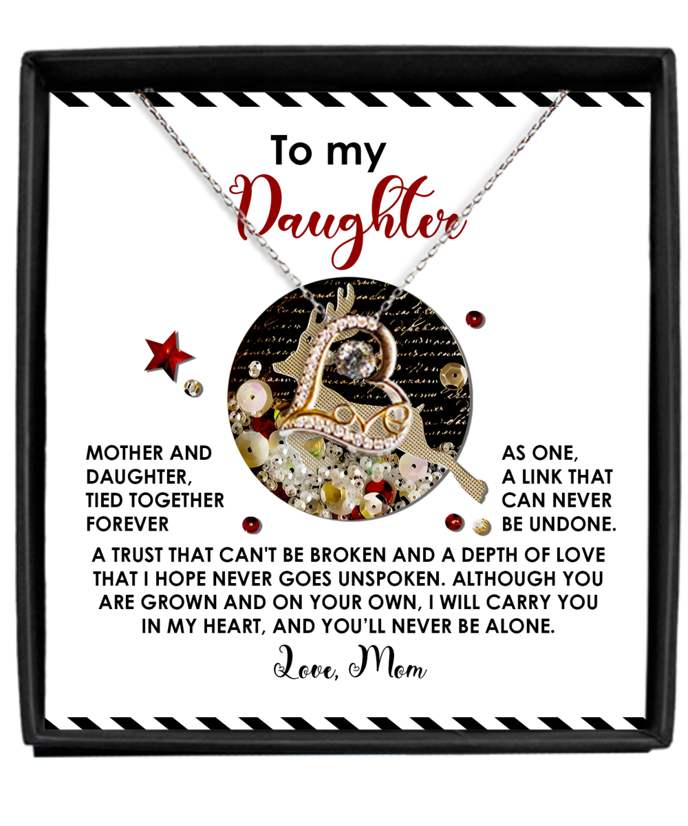 The Daughter-Forever As One - Love Dancing Necklace, packaged in a gift box with a heartfelt message titled "To my Daughter," conveys a mother's love and connection. Made of sterling silver, it features decorative elements and a touching note signed, "Love, Mom.