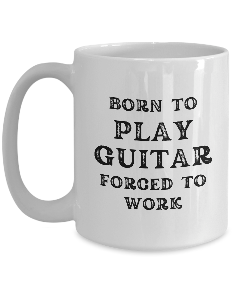 White coffee mug with black text, "Born to play guitar, forced to work," available for a limited time. Shipped from the USA. Perfect gift and appreciation cup for guitarists!.