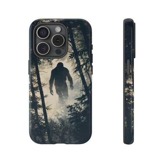 An iPhone 15 Pro case showcasing a shadowy Bigfoot figure against a dense forest backdrop, creating an eerie yet captivating visual that will intrigue any big foot lover.