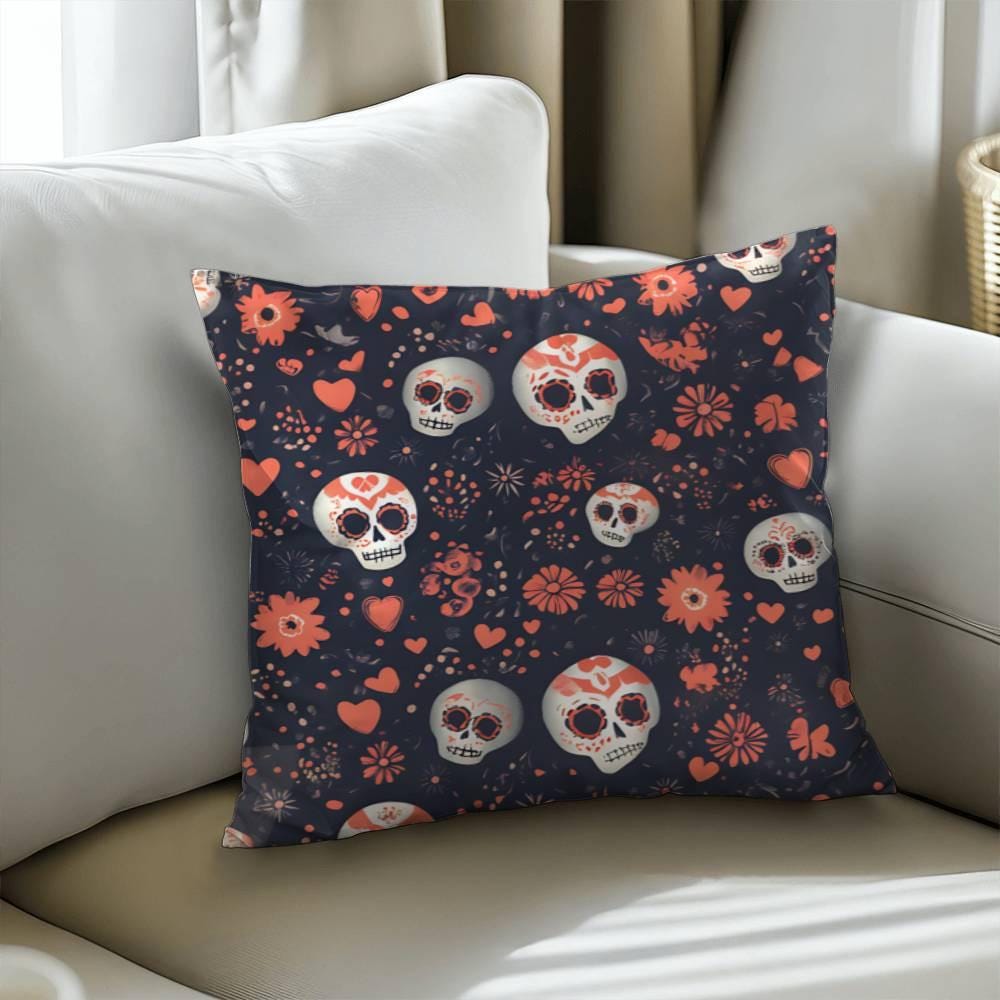 The Day of the Dead Mexican Skull Pillow, a perfect Halloween gift and spooky decor piece for skull lovers, showcases goth home decor with its dark background and pattern of white and orange skulls, hearts, and flowers. This Dia De Los Muertos decorative pillow rests elegantly on a beige sofa.