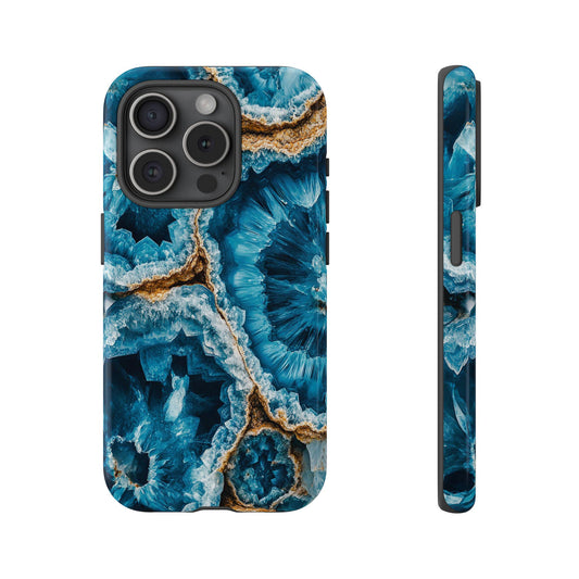 Front view and side view of an iphone 15 Pro March Birthstone Aquamarine Crystal Geode Design Phone Case featuring rich blue hues of the geode pattern radiate from a central point, capturing the intricate allure of crystal formations.