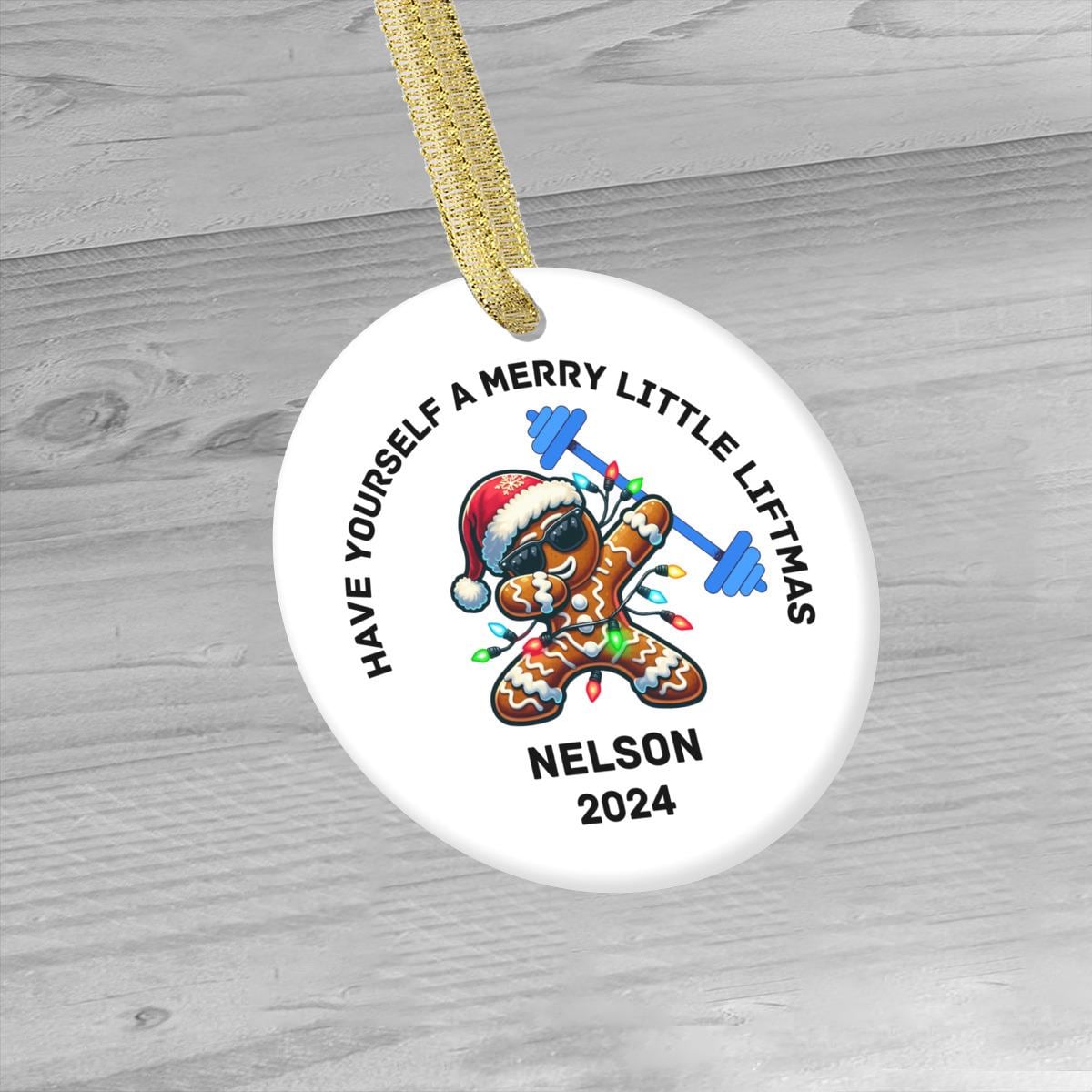 Perfect as a gym-themed Christmas gift, the Merry Liftmas Weightlifting Ceramic Ornament showcases a gingerbread man lifting weights while wearing a Santa hat and sunglasses. With "Have Yourself a Merry Little Liftmas, Nelson 2024" inscribed, it's an ideal choice for bodybuilders, weight lifters, swole mates, and gym lovers alike.