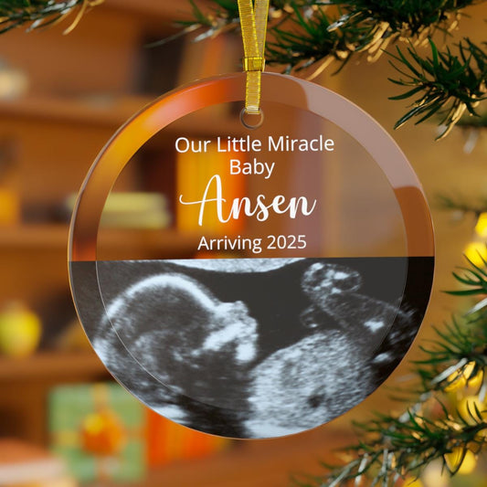 This Custom Ultrasound GLASS Ornament, a personalized keepsake for new parents, showcases a sonogram image with the message: "Our Little Miracle Baby Ansen Arriving 2025." Ideal as a pregnancy announcement gift, it celebrates the joy of new beginnings.