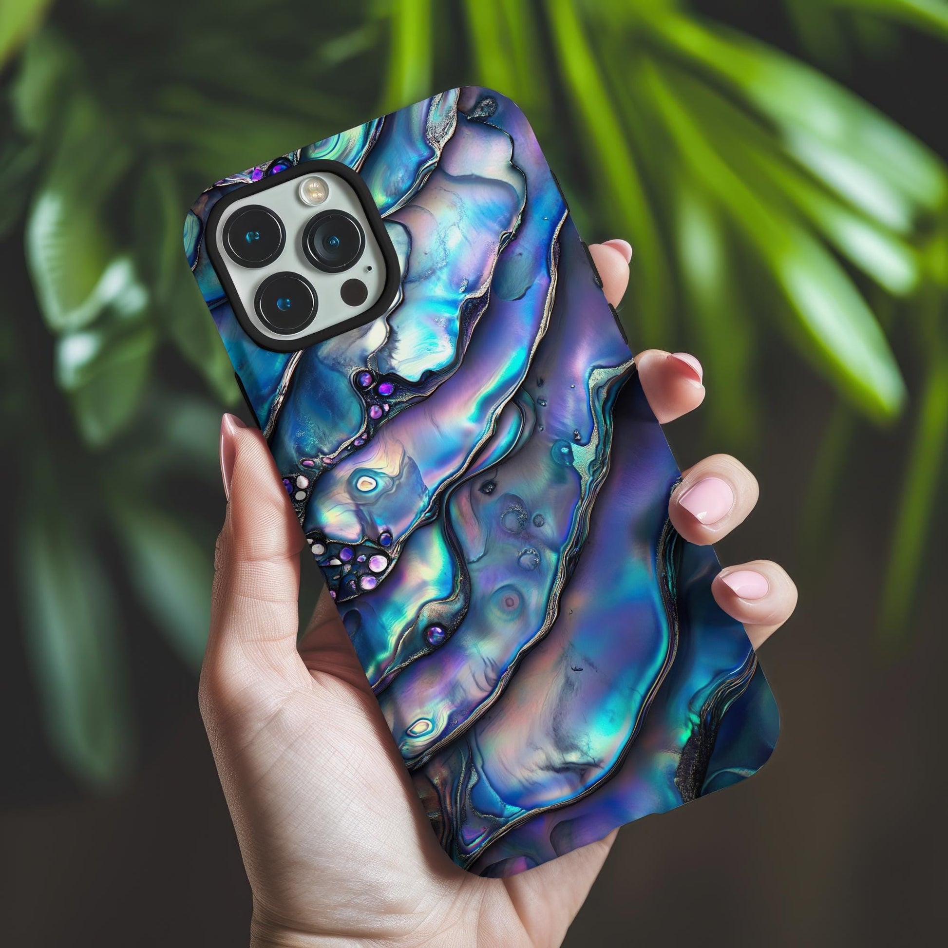The Golden Value SG Unique Abalone Shell Phone Case showcases a mesmerizing blend of blues, purples, and greens. Its iridescent surface features wavy patterns and shiny, rounded bumps for a captivating texture.