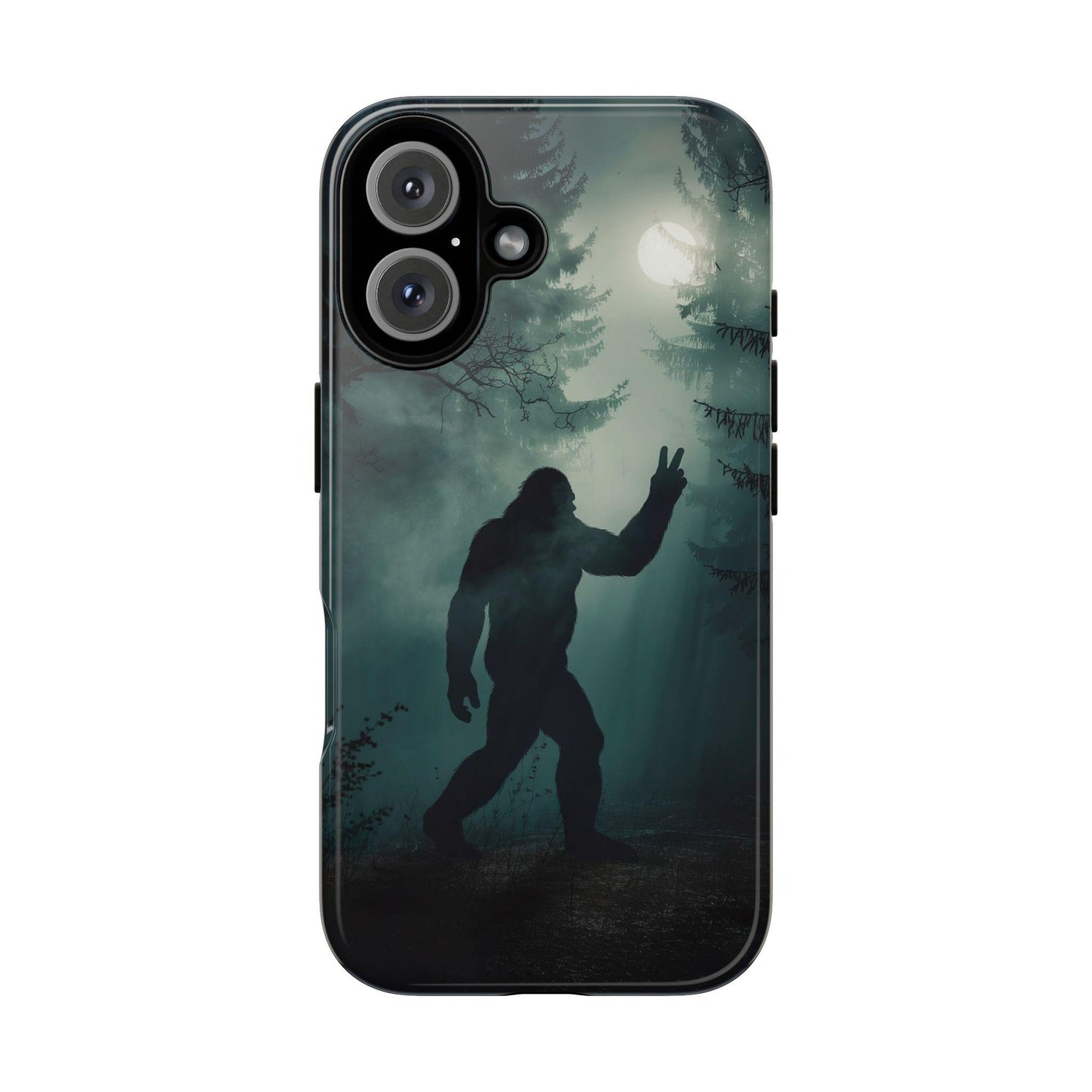 The Bigfoot Silhouette Phone Case by Golden Value SG features a shadowy, forested scene at night with a full moon casting an eerie glow through the trees. In the foreground, a large, hairy, humanoid figure resembling Bigfoot or Sasquatch is silhouetted against the moonlight. The creature is standing upright, with one arm raised, making a peace sign with its hand. The atmosphere is misty and mysterious, with tall pine trees and bare branches adding to the spooky ambiance.