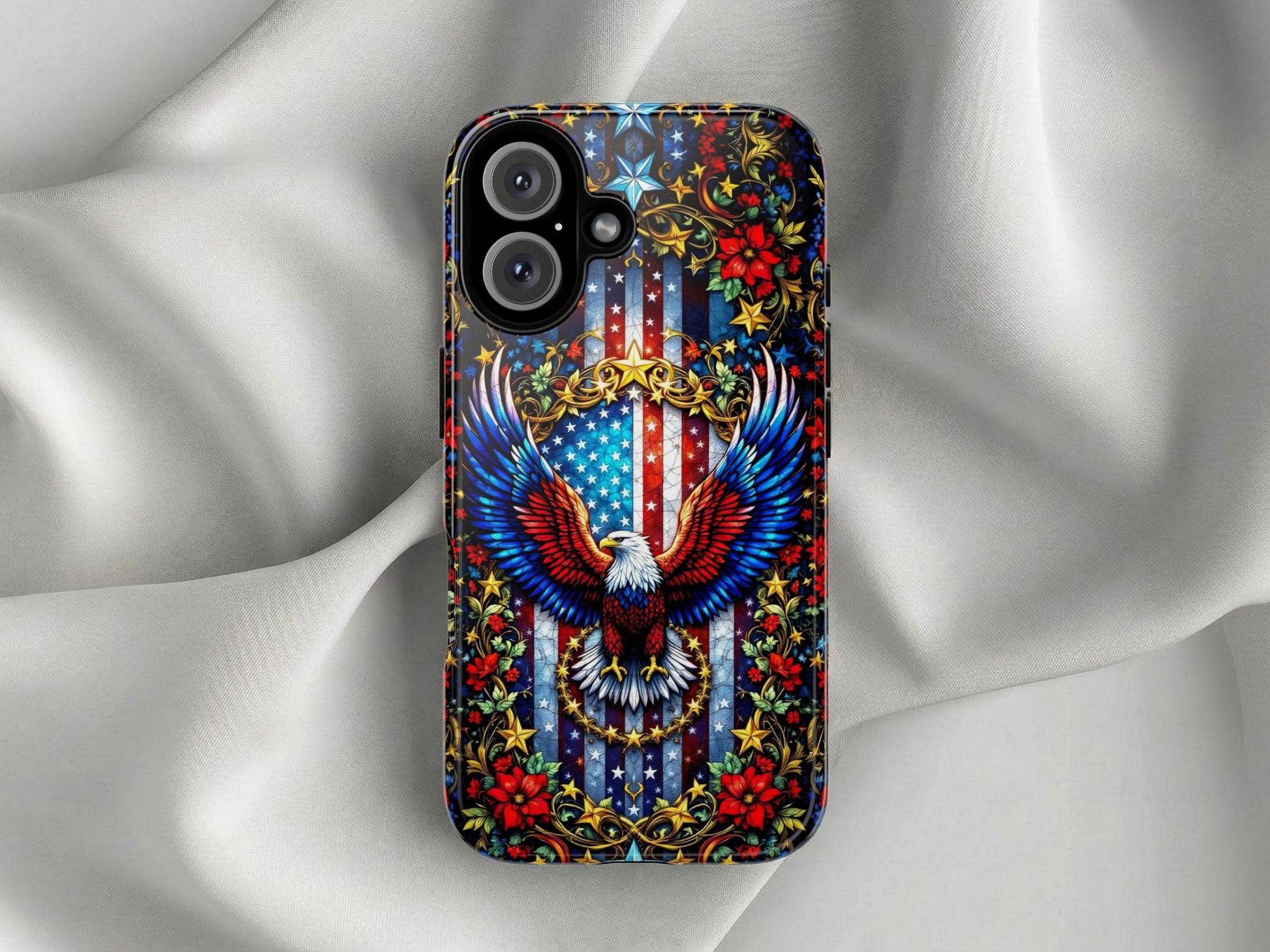 The Golden Value SG American Flag and Eagle Phone Case features a vibrant bald eagle with spread wings over a U.S. flag shield, gold scrollwork, red flowers, green leaves, and stars on a smooth white silk background.