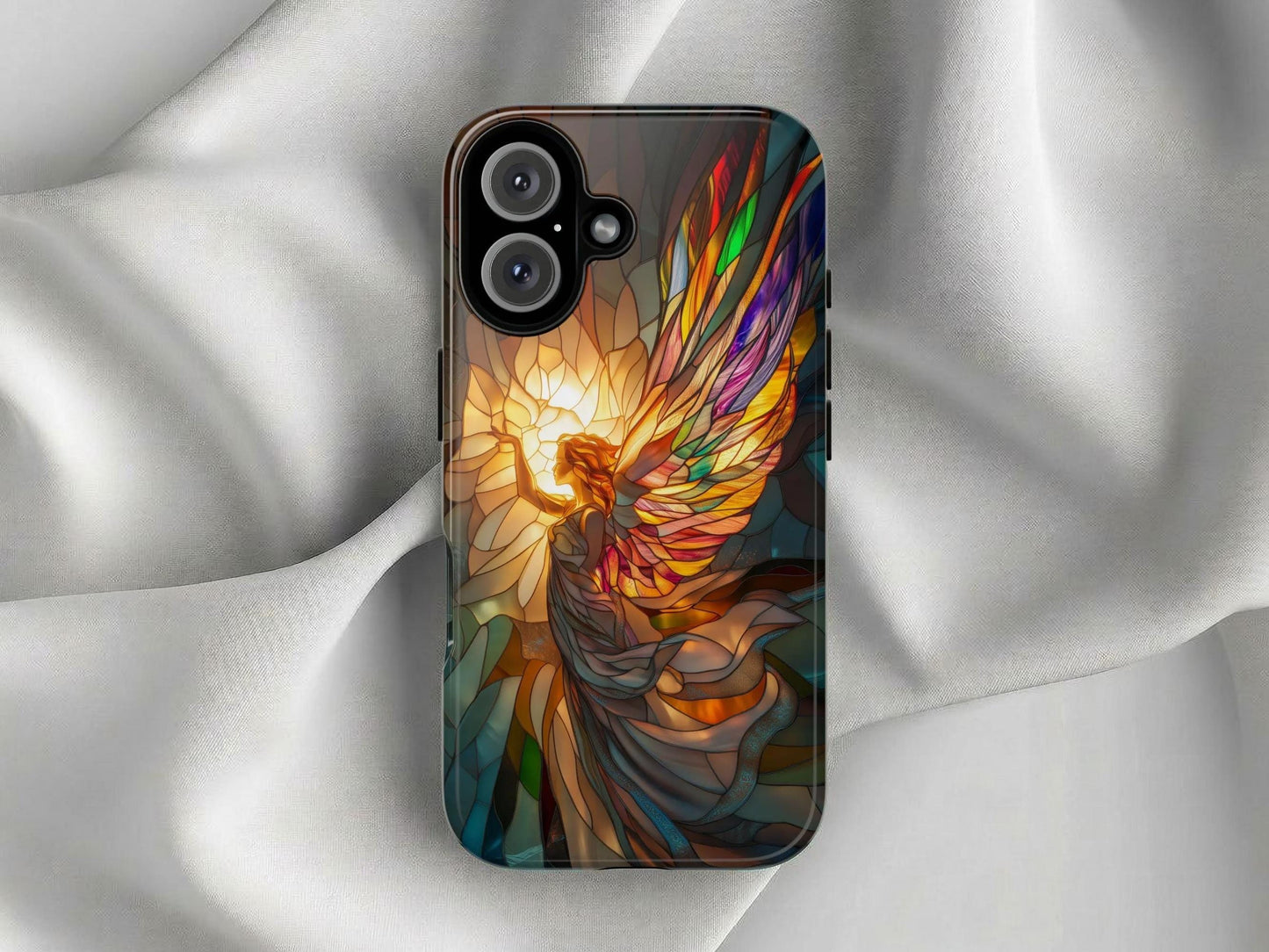The Golden Value SG Stained Glass Angel Phone Case features a vibrant illustration of an angel with multicolored wings reaching towards a luminous golden light, symbolizing serenity and spirituality. Set against a softly lit white silk background for striking contrast.