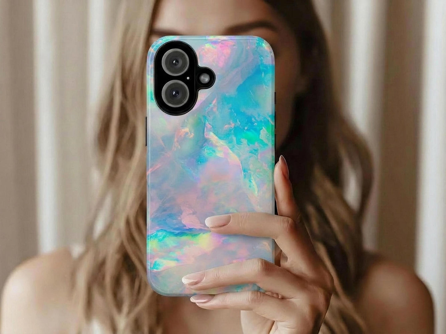 A person holds up a phone case with a pastel iridescent opal design, showcasing the glossy multicolored pattern.