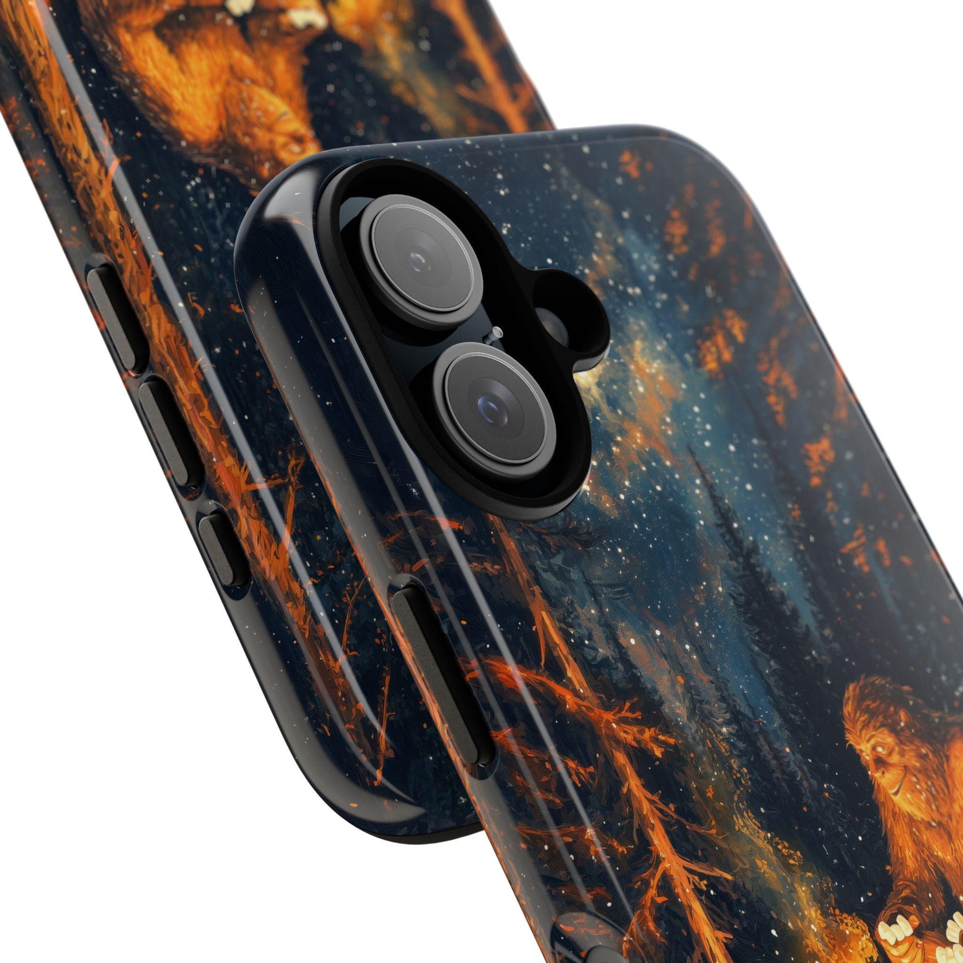 A close-up view of two phone cases featuring the Bigfoot campfire artwork, showing the side buttons and dual-camera cutout against a white background.