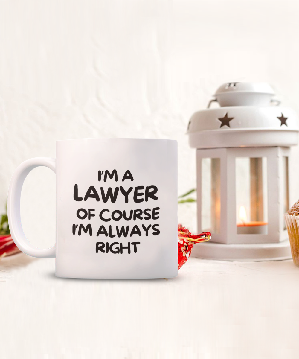 A limited-edition "I'm A Lawyer Of Course I'm Always Right Coffee Mug," perfect for lawyer gifts, sits beside a lit lantern and cupcake. Exclusively printed and shipped from the USA, it's not available in stores.