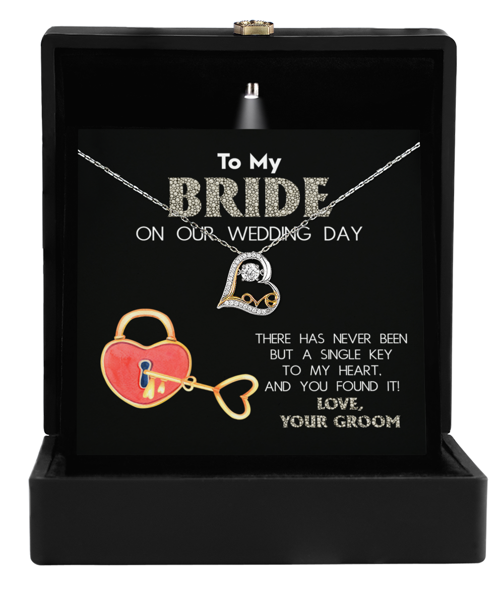 The Bride-A Single Key - Love Dancing Necklace rests in a black box with a heartfelt message: "To my bride on our wedding day. There has never been but a single key to my heart, and you found it! Love, your groom." This necklace is the perfect gift for a bride, beautifully capturing the essence of unity and love.