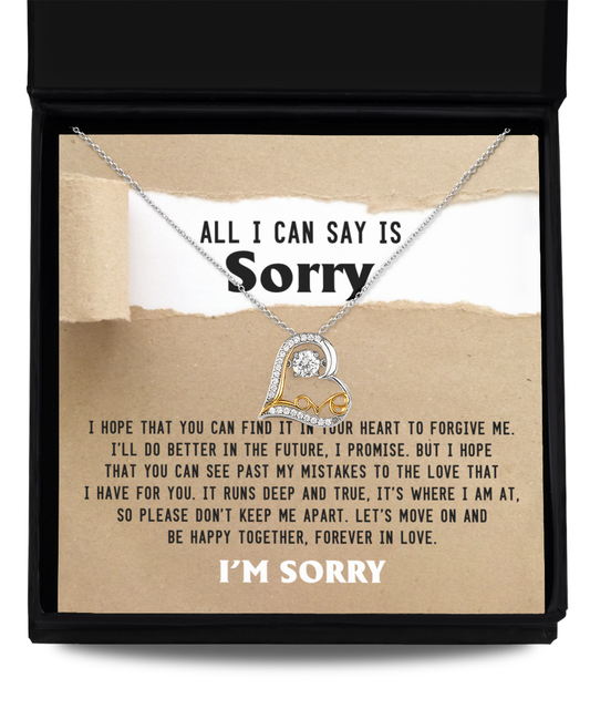 A Sorry-Keep Me Apart - Love Dancing Necklace featuring a heart pendant is displayed in a box. Crafted from 14k gold, the necklace comes with a note of apology, expressing hope for forgiveness and a commitment to do better in the future. The note ends with "I'M SORRY.