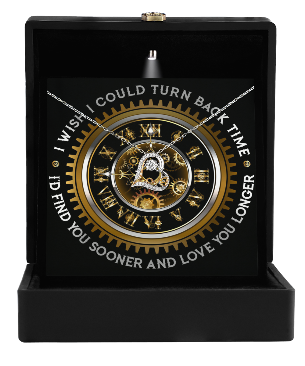 Presented in an open black box, the "To Wife-Turn Back Time-Love Dancing Necklace" features a clock design with gears and Roman numerals. It is adorned with the touching message, "I wish I could turn back time I'd find you sooner and love you longer," making it a perfect personalized gift plated in radiant 14k gold.