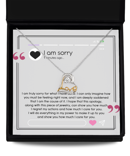 A sterling silver heart-shaped necklace, named the Sorry-Care For You - Love Dancing Necklace, is elegantly showcased in an open box with an apology message inscribed inside. The message conveys profound regret, love, and a promise to make things right.