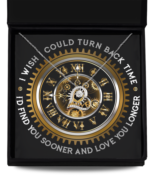 The "To Wife-Turn Back Time- Love Dancing Necklace" features a heart-shaped pendant crafted from sterling silver and adorned with a clockwork design. This elegant necklace comes in a black box, surrounded by Roman numerals and gears, and bears the poignant inscription: "I wish I could turn back time. I'd find you sooner and love you longer.