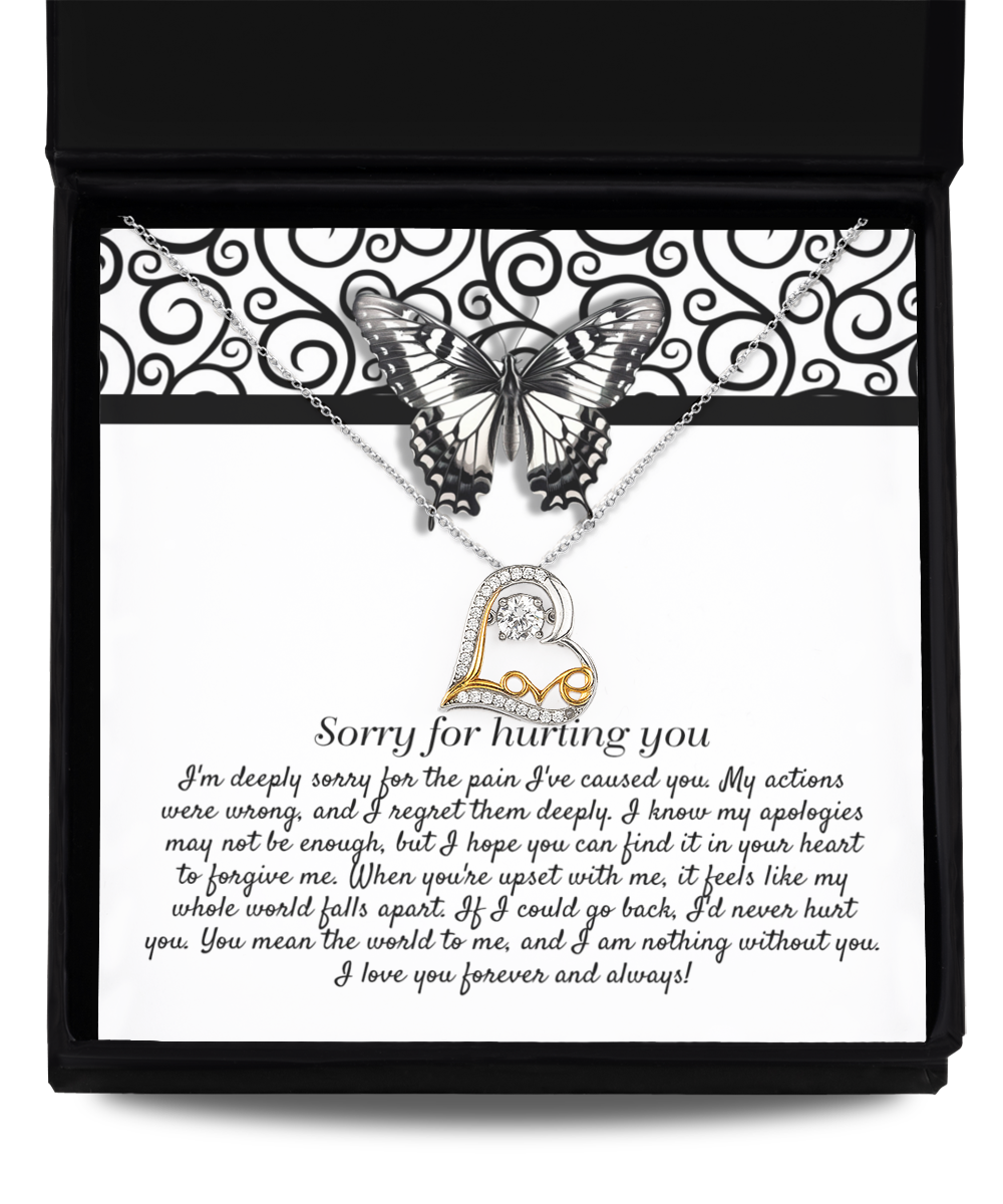 The Sorry-Nothing Without You - Love Dancing Necklace is a .925 sterling silver piece featuring a pendant of interlocking hearts. It is beautifully displayed on a card adorned with an apology message and a butterfly graphic, all elegantly packaged in a black box. The text on the card conveys regret and love.