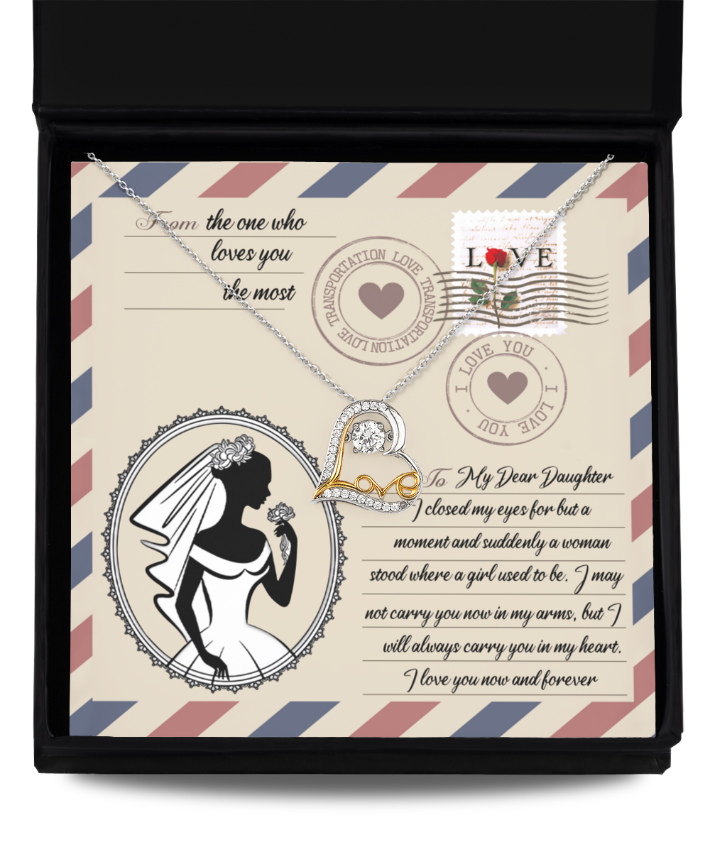 A Daughter Wedding-In My Arms - Love Dancing Necklace is displayed in a box with a decorative card. The card features a silhouette of a bride, stamps, and a heartfelt message to a daughter from a parent.