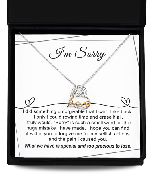 The "Sorry-Breaking My Heart - Love Dancing Necklace," meticulously crafted from .925 Sterling Silver and featuring a heart pendant, is displayed in an open jewelry box. A heartfelt message on the insert expresses regret for past actions and hopes for forgiveness.