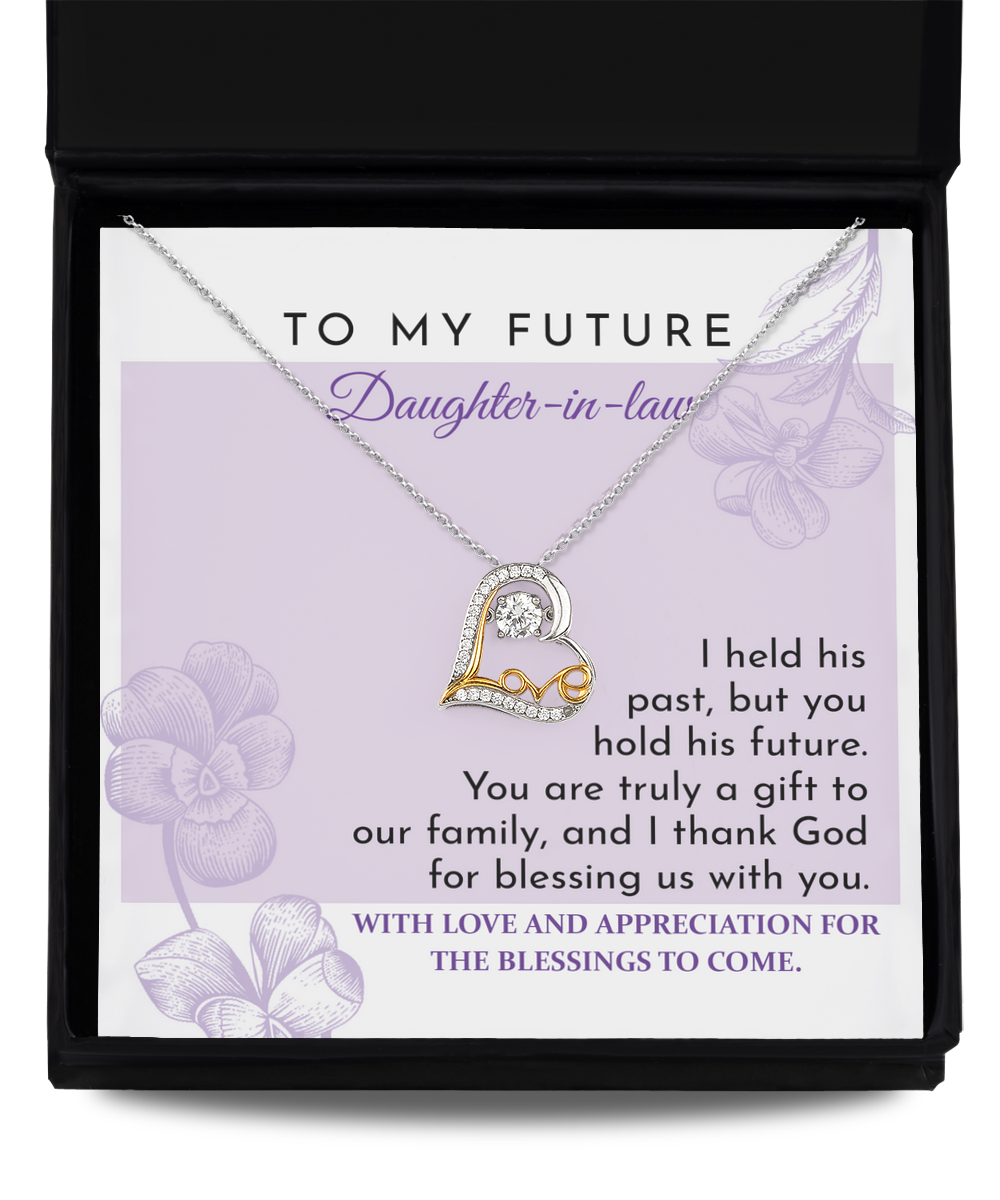 A "To Daughter-in-law, A Gift - Love Dancing Necklace" lies on top of a card in a black box. The card has a message expressing love and appreciation for a future daughter-in-law.