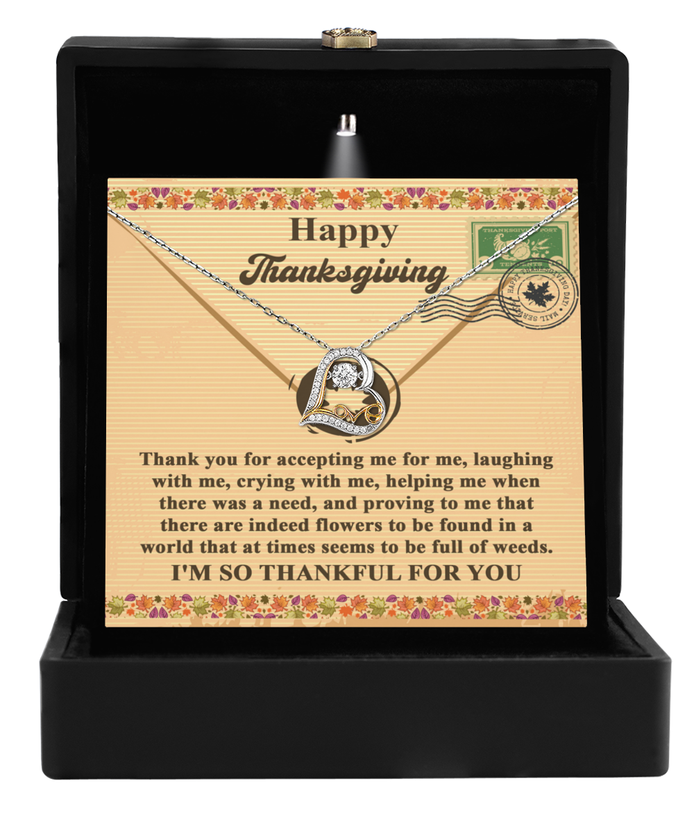 The Thanksgiving-Proving To Me - Love Dancing Necklace, crafted in sterling silver, is elegantly displayed in a black box along with a card reading "Happy Thanksgiving" and featuring a heartfelt gratitude message.