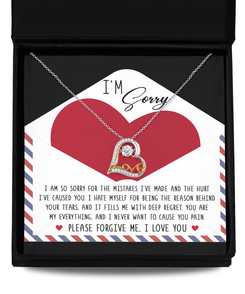 A heart-shaped Sorry-Behind Your Tears - Love Dancing Necklace with an apology message in a gift box. The 14k gold pendant reads, "I'm sorry. I am so sorry for the mistakes I've made and the hurt I've caused you. Please forgive me. I love you.