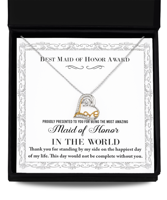 The "To Maid of Honor-Of My Life - Love Dancing Necklace," crafted from .925 Sterling Silver and featuring a heart-shaped pendant, is beautifully presented in an open box along with a printed certificate. The certificate proclaims "Best Maid of Honor Award" and conveys heartfelt gratitude for being the most amazing Maid of Honor, emphasizing that the day wouldn't be complete without her.