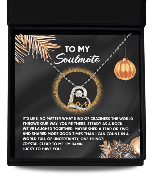 A 14k gold Soulmate-I Can Count - Love Dancing Necklace nestled in a box with a message to a soulmate, surrounded by holiday-themed decorations.