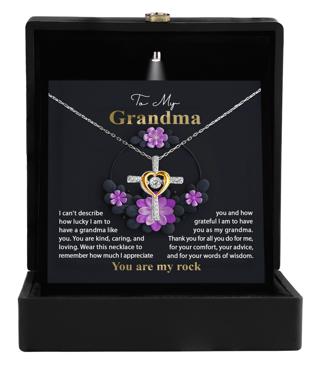 A Grandma Necklace with a heart-shaped pendant in a gift box featuring a sentimental message dedicated to Grandma: To Grandma, Words Of Wisdom - Cross Dancing Necklace by Gearbubble.