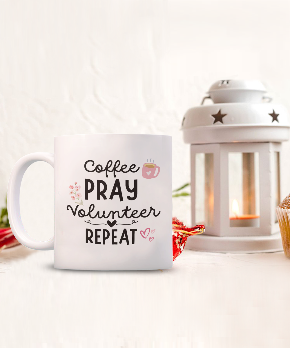 The "Coffee Pray Volunteer Repeat" mug, perfect for volunteers, is featured beside a candlelit lantern. Available for a limited time with guaranteed safe checkout. Each mug is carefully printed and shipped to ensure your satisfaction.