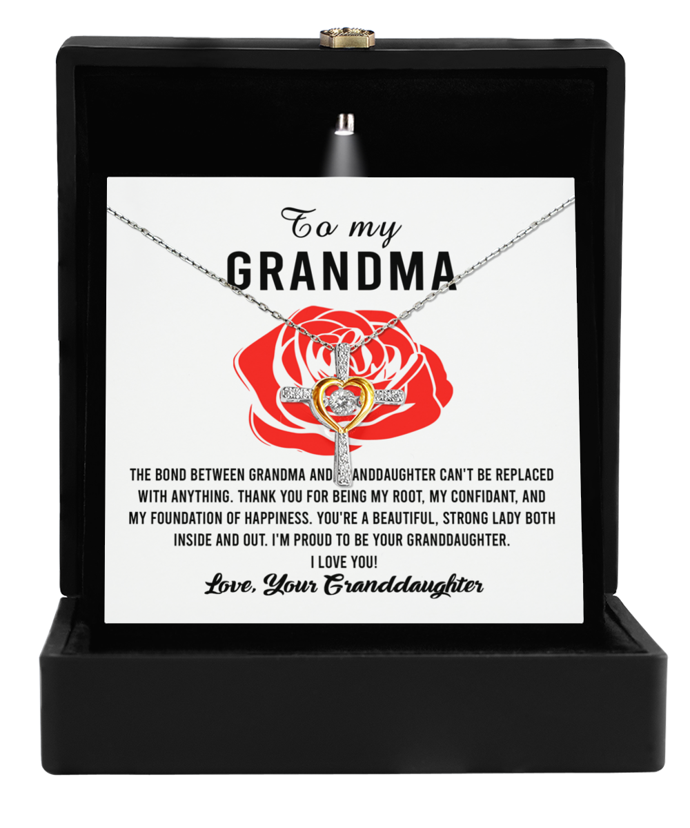 A To Grandma, Strong Lady - Cross Dancing Necklace by Gearbubble, presented in a black box as a 14k gold plated grandma granddaughter necklace.