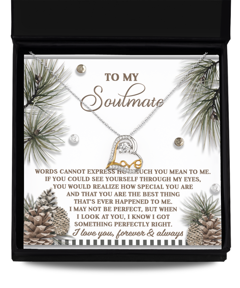 The Soulmate-Perfectly Right - Love Dancing Necklace is a stunning piece crafted from sterling silver, featuring intertwined hearts. It comes elegantly enclosed in a gift box, with the lid displaying a heartfelt message for a soulmate and adorned with charming pinecone and greenery illustrations, making it an ideal symbol of love.