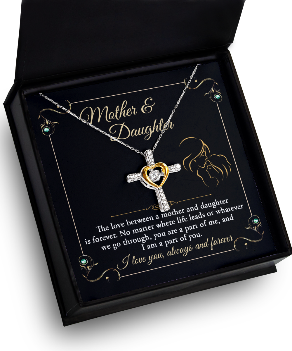 A heart-shaped Mother Daughter, Part Of Me - Cross Dancing Necklace in a box with "mother & daughter" text and a message about the love between a mother and daughter.