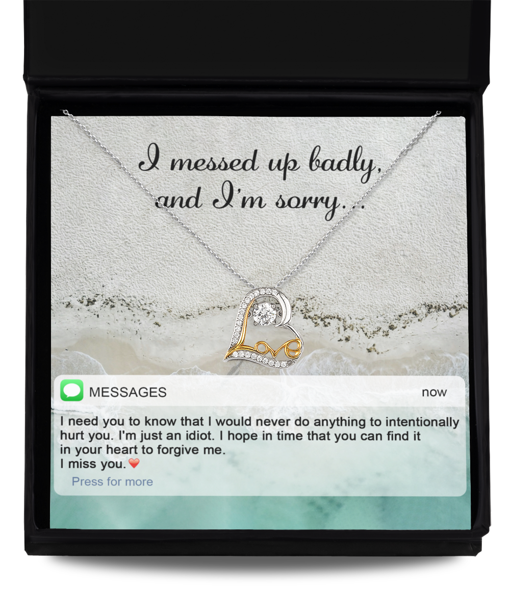 A jewelry gift box containing the "Sorry-Just An Idiot - Love Dancing Necklace," a 14k gold plated heart-shaped necklace, along with a heartfelt message reading "I messed up badly, and I'm sorry," and a text message expressing regret and requesting forgiveness.