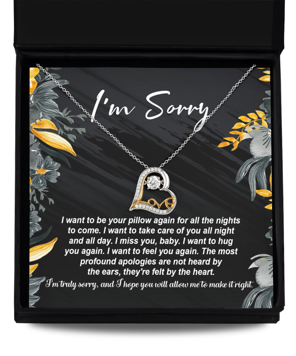 The Sorry-Be Your Pillow - Love Dancing Necklace features a 14k gold necklace with a heart-shaped pendant, elegantly presented in a box alongside an apology note that reads "I'm Sorry," accompanied by a heartfelt message expressing how much you miss and want to comfort the recipient. This exquisite piece beautifully combines elegance and sentiment.