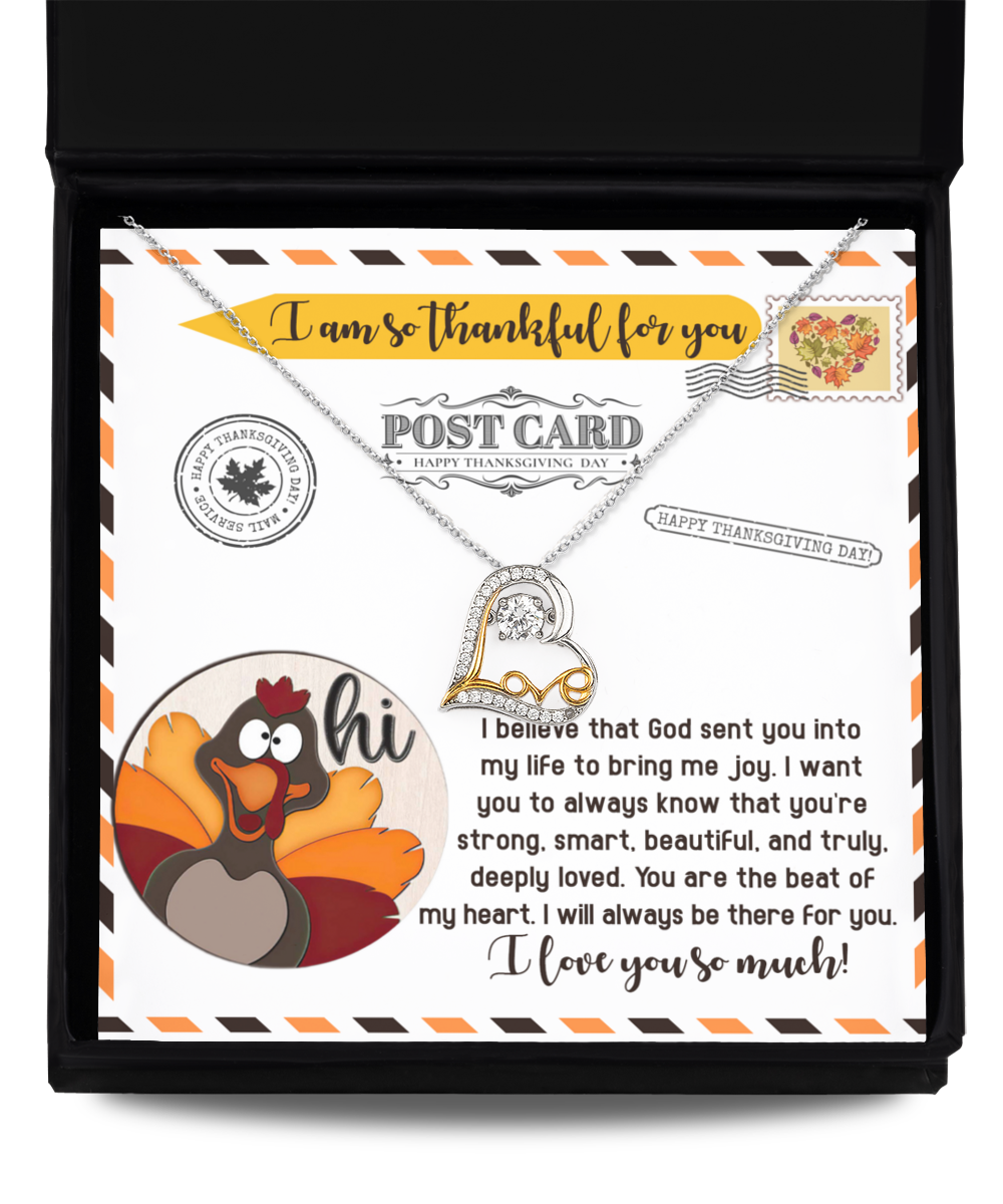 The Thanksgiving-The Beat - Love Dancing Necklace, featuring a heart-shaped pendant crafted from sterling silver, is elegantly presented on a greeting card adorned with a cartoon turkey and thoughtful Thanksgiving messages.