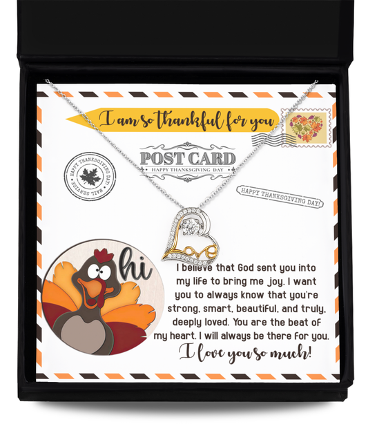 The Thanksgiving-The Beat - Love Dancing Necklace, featuring a heart-shaped pendant crafted from sterling silver, is elegantly presented on a greeting card adorned with a cartoon turkey and thoughtful Thanksgiving messages.