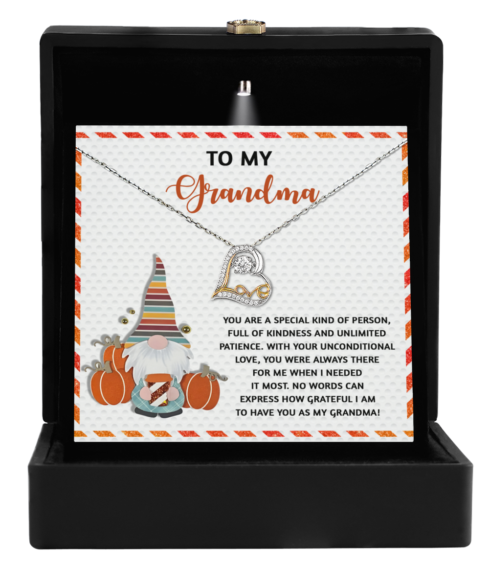 Gift box containing the "Grandma-Needed It Most - Love Dancing Necklace" along with a card addressed to "Grandma," featuring a gnome graphic and a heartfelt message expressing gratitude and love.