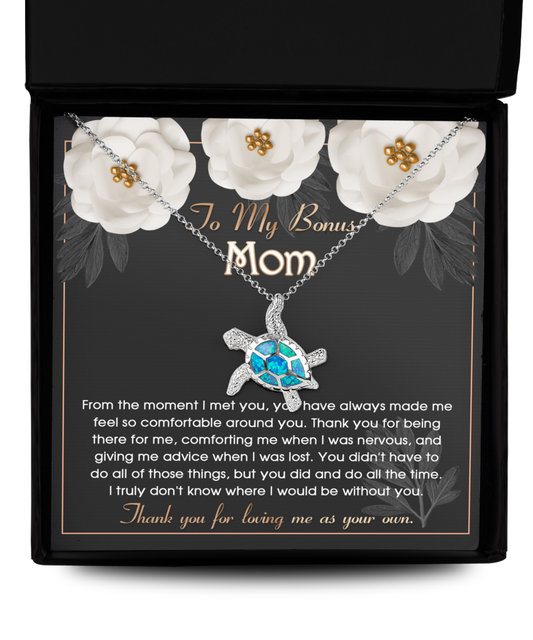 A necklace with a Gearbubble Opal Turtle pendant inside a gift box featuring a heartfelt message to a Bonus Mom.