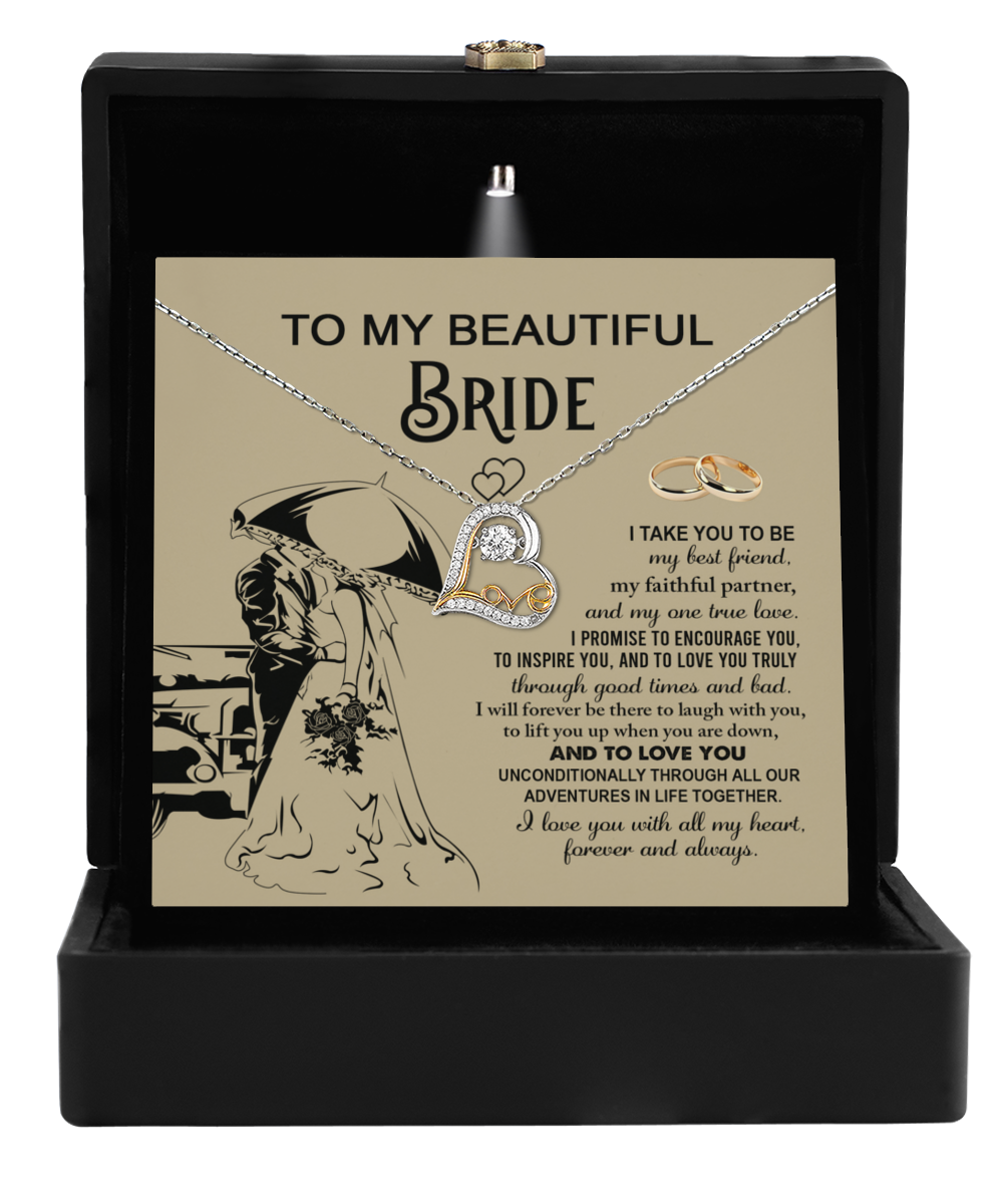 The Bride-Faithful Partner - Love Dancing Necklace gift set features a heart pendant along with a sincere wedding vow message, accompanied by graceful ring illustrations. It is elegantly packaged in a sleek black box, making it the perfect gift for the bride to celebrate timeless love and elegance.