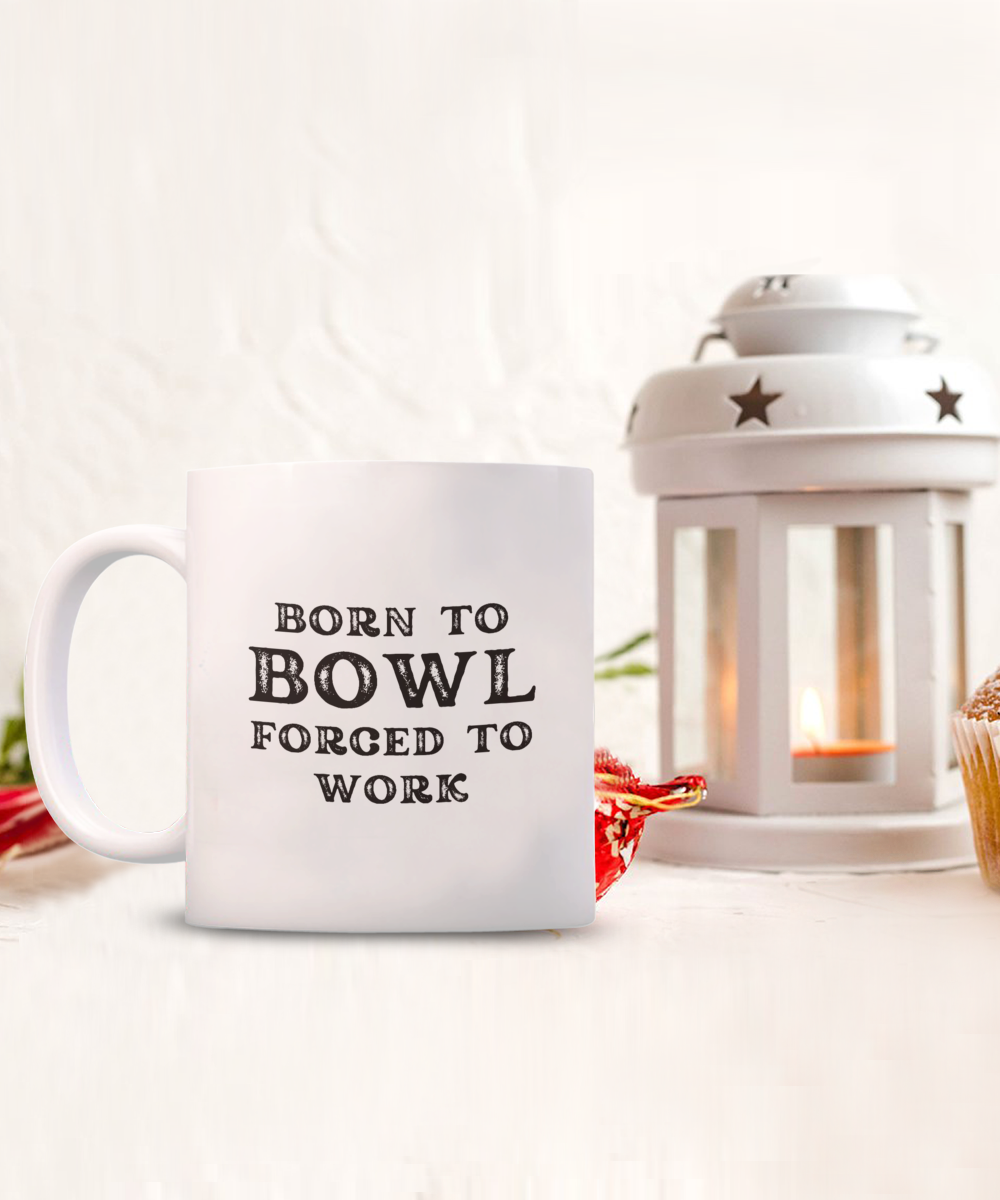 The "Born to Bowl Forced to Work" coffee mug, featuring a white lantern with a lit candle, is a delightful limited-time item printed and shipped from the USA. This unique bowler gift isn't available in stores.