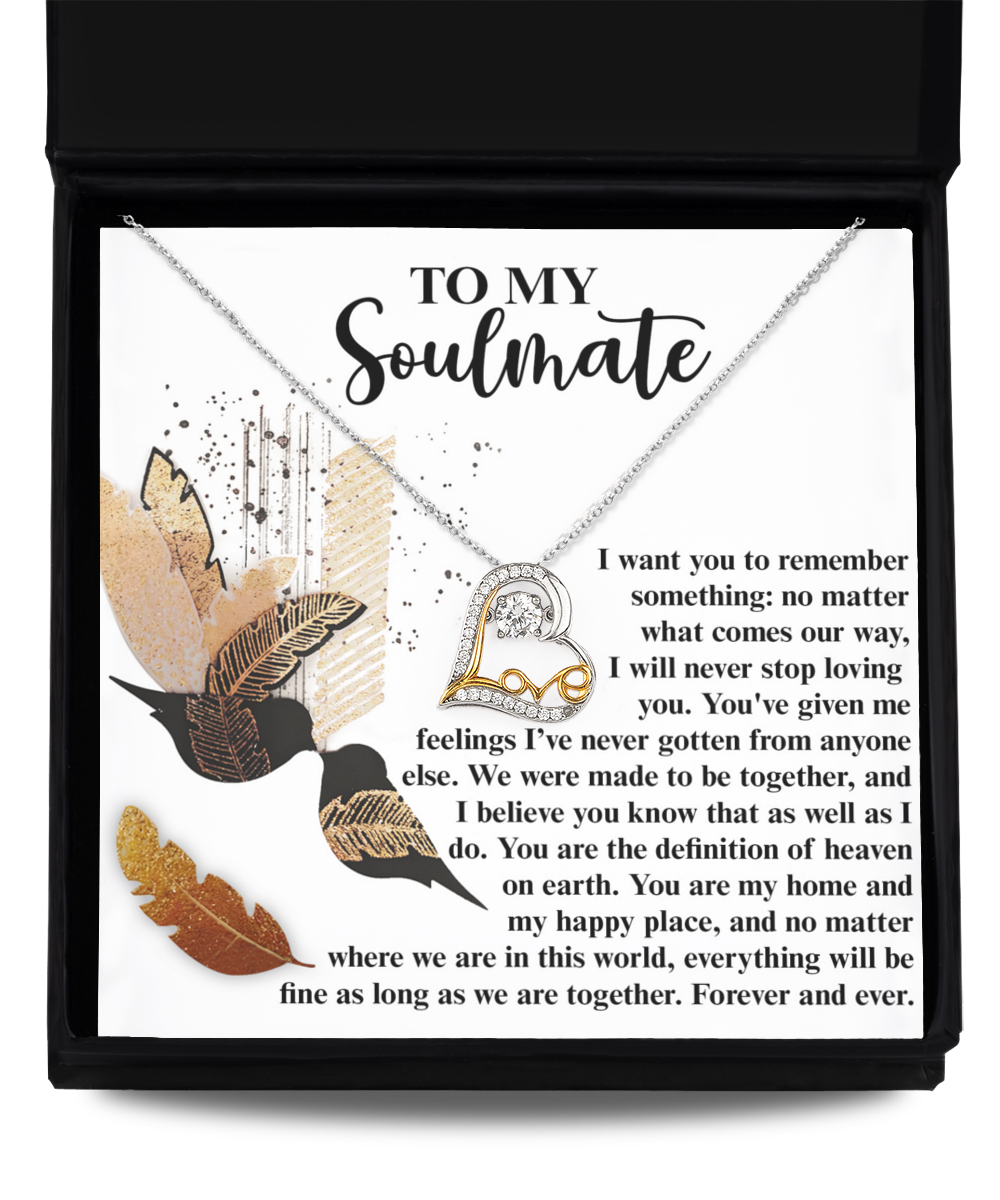 The Soulmate-Given Me Feelings - Love Dancing Necklace showcases a heart pendant crafted in 14k gold, nestled within a box that is decorated with feather illustrations and a romantic poem titled "To My Soulmate.