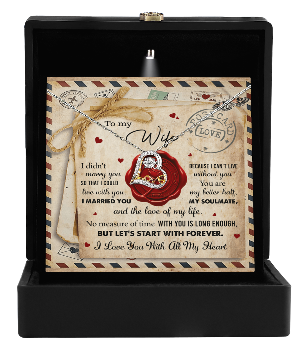 The Wife-Marry You - Love Dancing Necklace, adorned with a 14k gold heart-shaped pendant, is elegantly displayed in an open black box with a romantic message dedicated to a wife in the background.