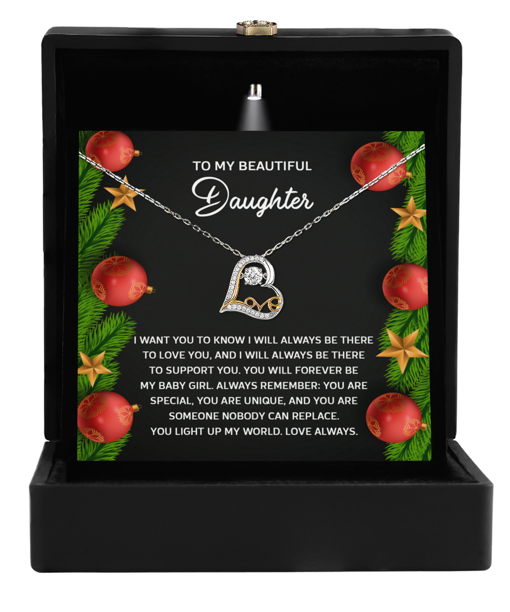 The Daughter-Nobody Can Replace - Love Dancing Necklace, featuring intertwined heart and infinity symbols, is elegantly packaged in a gift box with a heartfelt message to a daughter amid Christmas ornaments, embodying the spirit of maternal love.