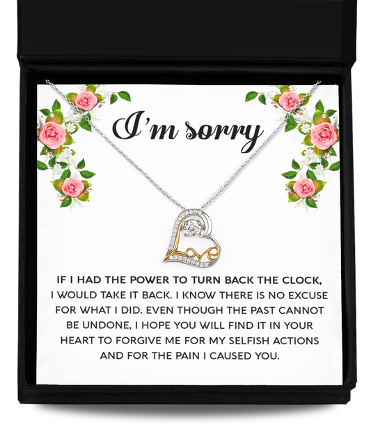 The Sorry-Make It Right - Love Dancing Necklace features a heart-shaped pendant crafted from genuine .925 Sterling Silver and is embellished with AAAA Cubic Zirconia. This exquisite necklace comes inside a box adorned with floral designs, accompanied by a heartfelt message that reads, "I'm sorry," followed by a detailed apology text.