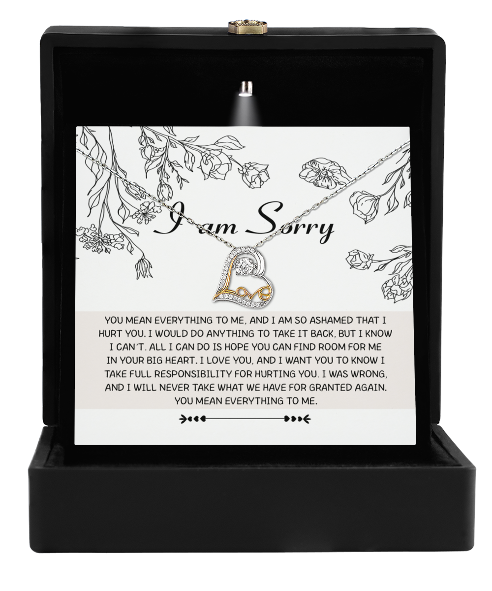 The "Sorry-Your Big Heart - Love Dancing Necklace" is presented in an open black box, featuring a heart-shaped pendant alongside a card conveying an apology for past mistakes. It serves as a graceful representation of maternal love and heartfelt regret.