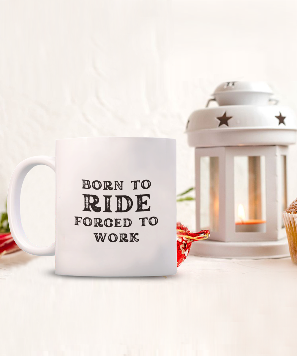 The Born to Ride Forced to Work Coffee Mug, a perfect gift for bikers, pairs elegantly with a candle lantern and plant. Printed and shipped from the USA, it's available for a limited time. Enjoy safe checkout when you order today.