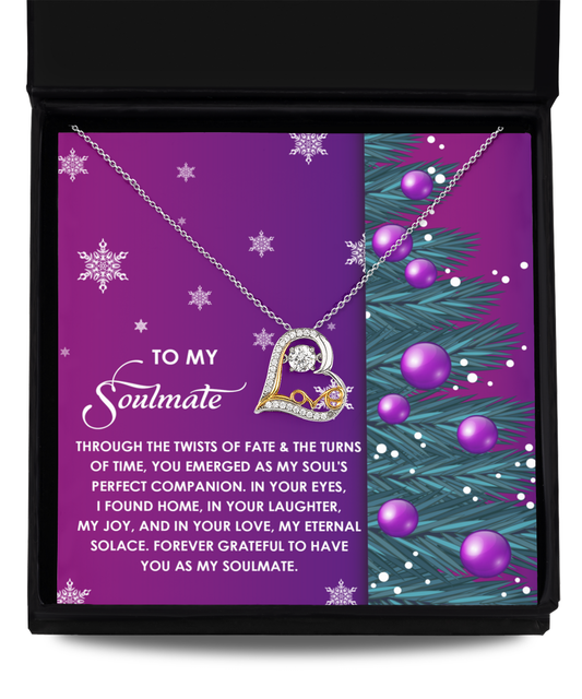 The Soulmate-Perfect Companion - Love Dancing Necklace, exquisitely crafted in 14k gold and heart-shaped, is beautifully showcased in a black box set against a purple background. It is embellished with snowflakes and a holiday-themed design. Accompanied by a card that conveys a heartfelt message to your soulmate, it perfectly encapsulates the essence of eternal love.