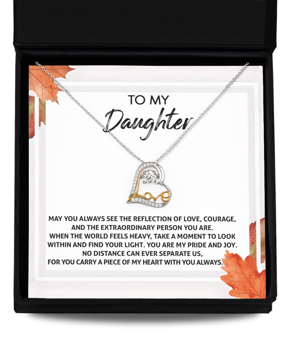 The Daughter-Find Your Light - Love Dancing Necklace is a heart-shaped necklace presented in an open box with a heartfelt message for a daughter. Crafted from sterling silver, it features an autumn leaves design, symbolizing timeless affection.